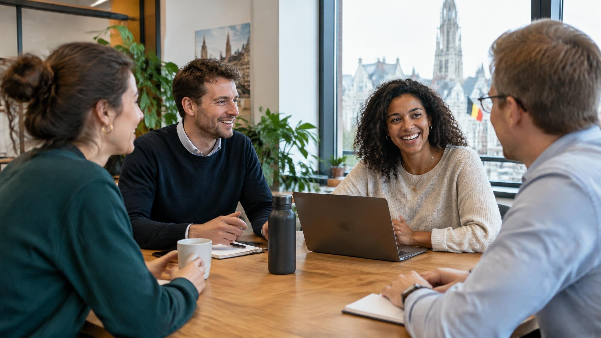 Group of colleagues having a friendly discussion around a table
